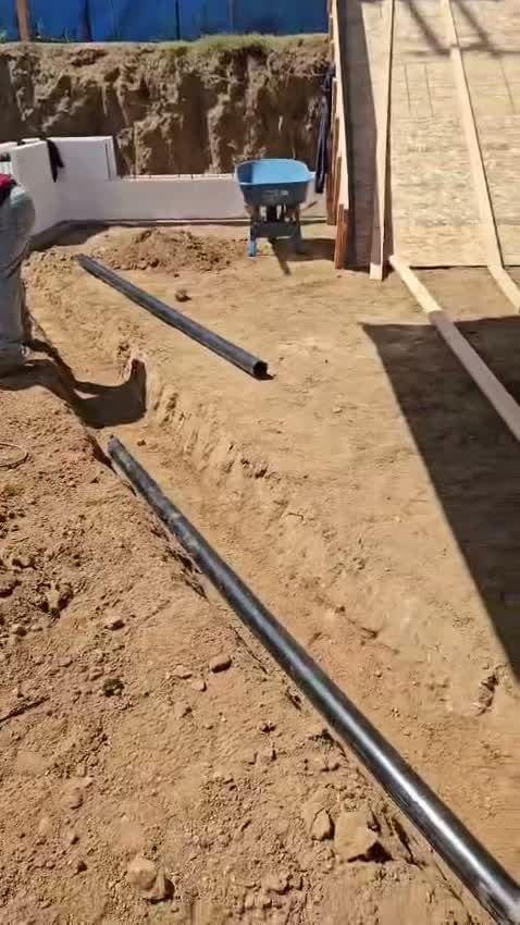 Drain pipe laid out in a trench at the foundation