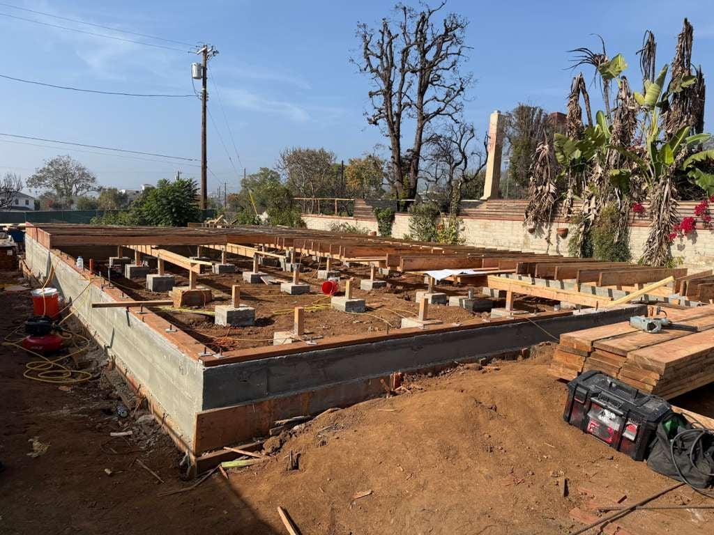 Concrete stem-wall foundation with wood floor framing underway on a Mars Civil project