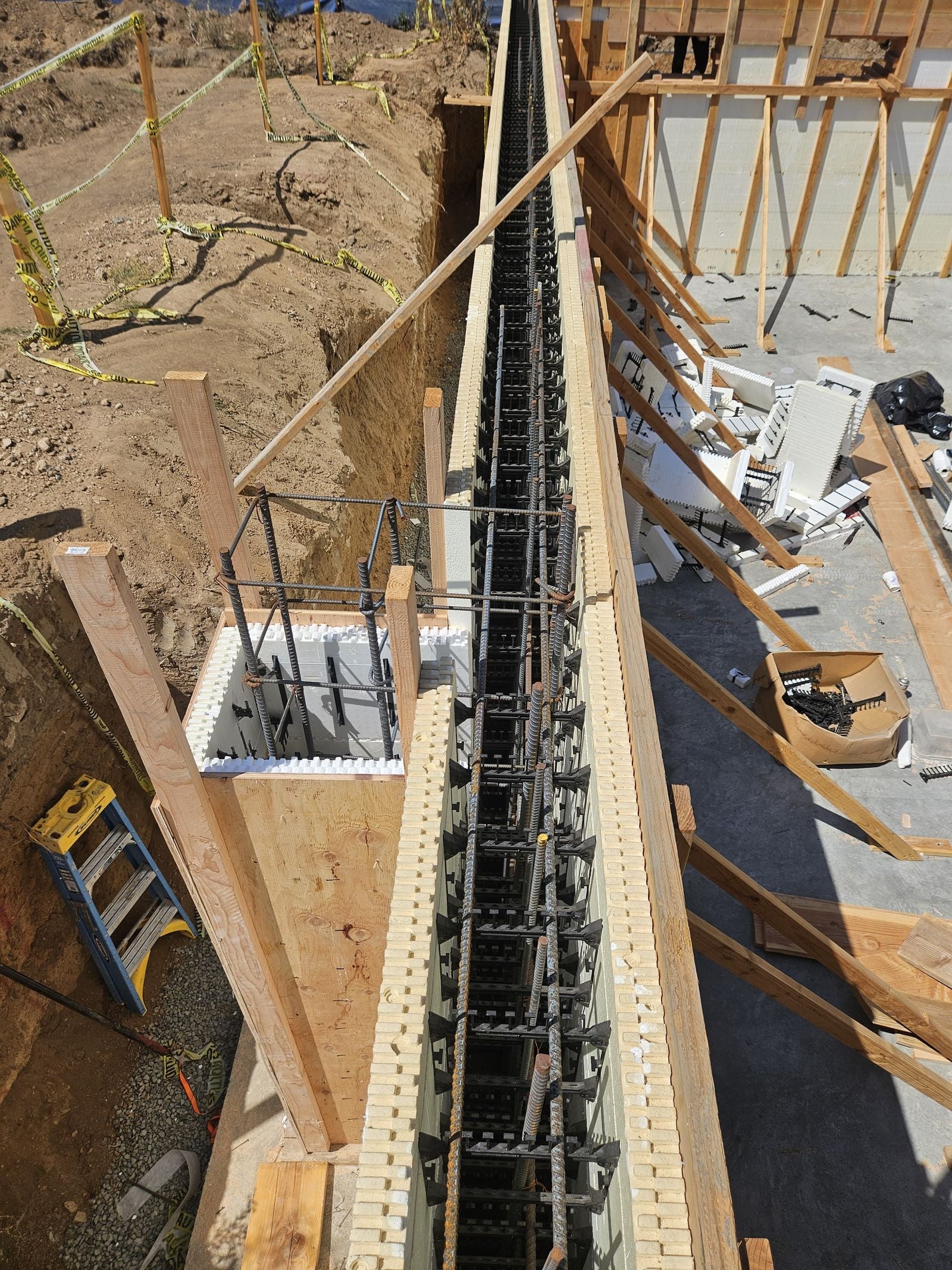 ICF wall forms packed with rebar above a finished concrete slab